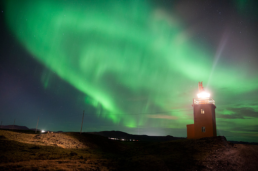 Incredible Aurora Borealis at the Hopsnes Lighthouse in Iceland.Powerful Northern Lights