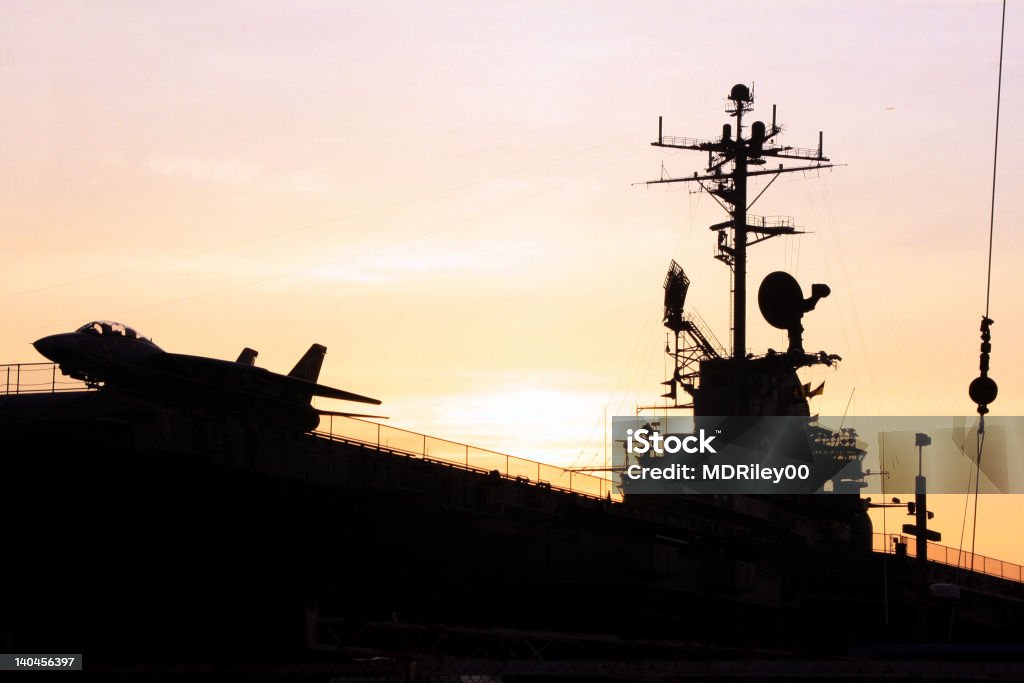 Carrier, Jet and Bridge Silhouette As the sun set over the San Francisco Bay, it silhouetted the jet and the bridge on the carrier. Carrying Stock Photo