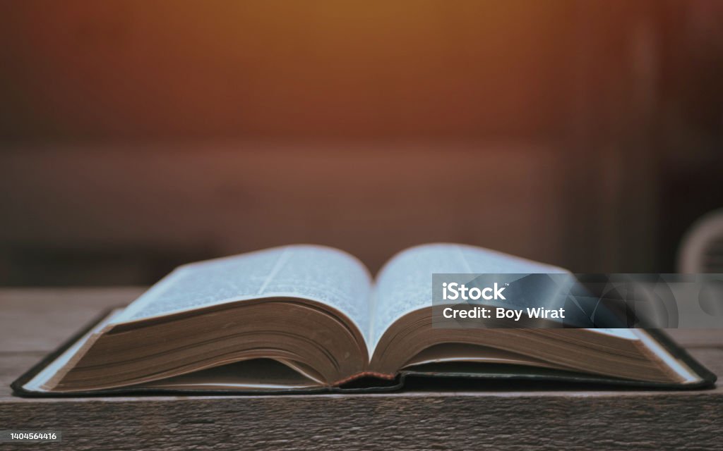 Open Bible on a Slate Tabletop with Customizable Space to Add Text Bible Stock Photo