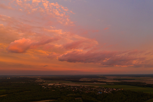 Beautiful pink clouds in sky. Sustainable development. Ecosystem. Conservation of biodiversity. Aerial view. Summer background. Drone photography. Earth. Sustainability. Atmospheric landscape. Sunset