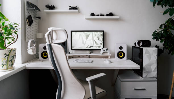 Front view comfortable home office workplace of photographer with computer, camera lens Front view comfortable home office workplace of photographer with computer, camera lens different types. White minimalistic interior for working, business and entertainment digital online game playing gaming chair photos stock pictures, royalty-free photos & images