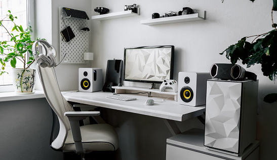 View comfortable home office workplace of creator with computer, camera lens different types. White minimalistic interior for working, business and entertainment digital online game playing