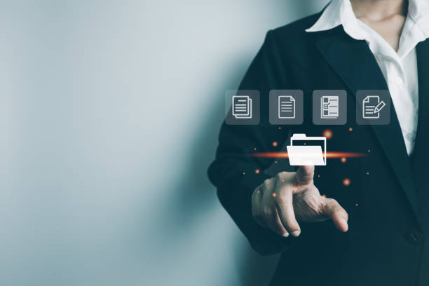 istock Businesswoman use finger touch screen folder manage file,online data management,Document Management System DMS,access to document file with security,structure design document,ERP enterprise 1404566822