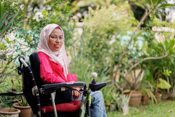 Malaysian Muslim Paraplegic Artist Outdoor Portrait in The Garden stock photo