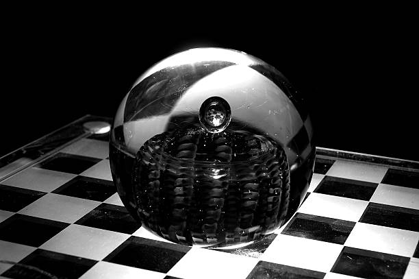 Checker Looking Glass A glass ball reflecting a black and white chess board esher stock pictures, royalty-free photos & images