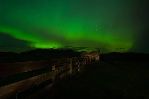 Northern Lights, an old fence and shack stock photo