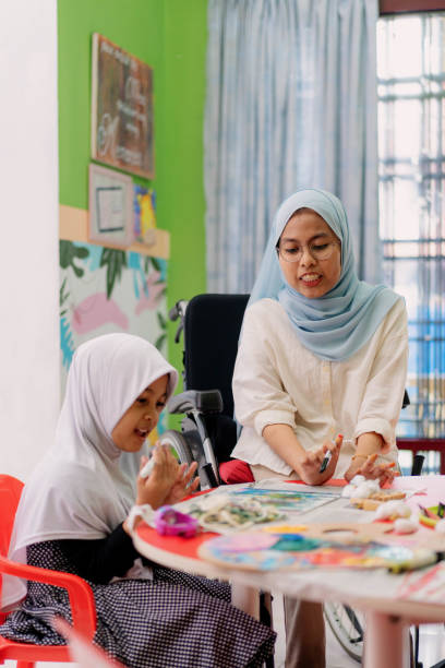 istock Muslim Art Teacher Having Craft Workshop Helping A Female Student 1404574211