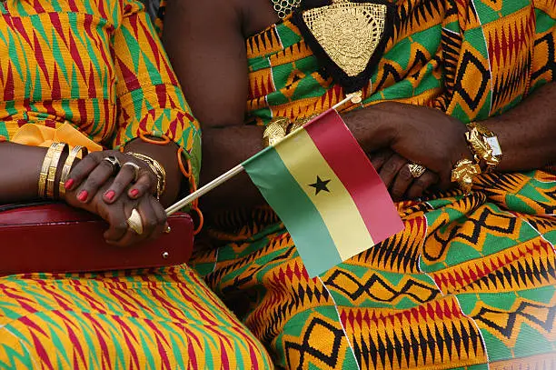 The wives of two tribal chiefs celebrate the 50th anniversary of Ghana's independence from England.