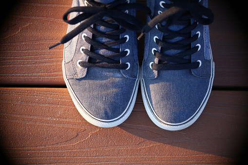 top view of canvas shoes on a wooden deck