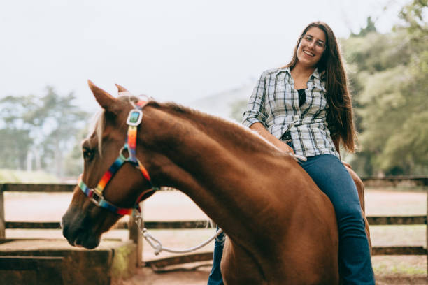 istock Smiling girl riding horse 1404581324