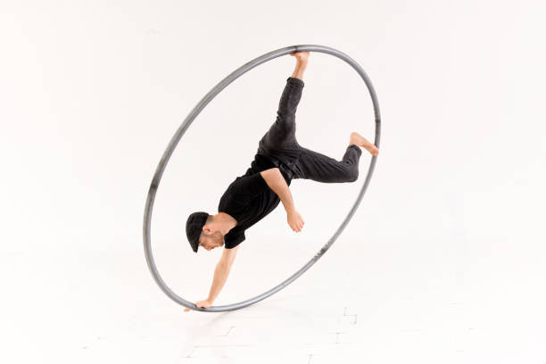 istock Acrobat performing trick with cyr wheel 1404585594