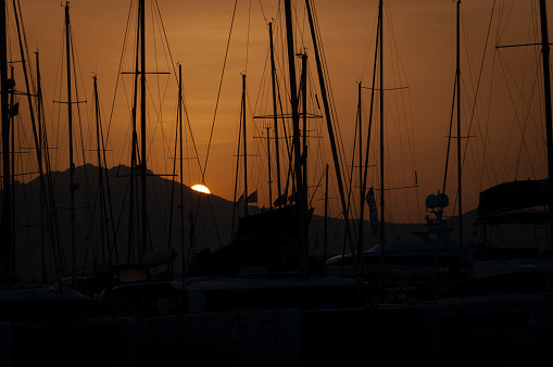 Olbia, Sardinia / Italy - 2019/8/21: Panoramic view of marina di Olbia port and yacht marina at sunset
