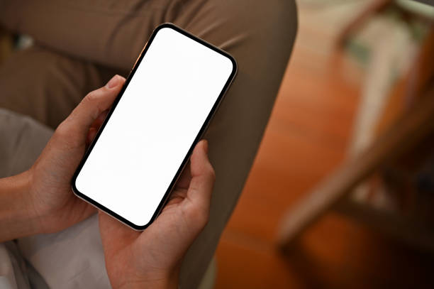 istock Top view, A smartphone with screen mockup is in a male's hands over his lap. 1404586779