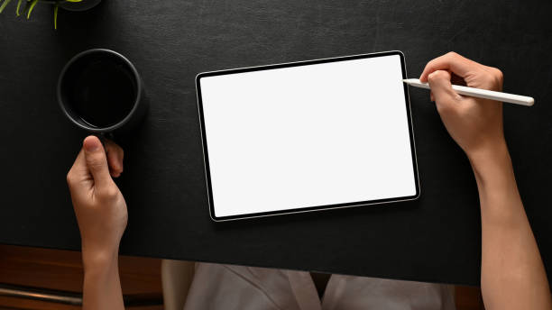 istock Top, A man designing his artwork on digital tablet with stylus pen at his modern dark office desk. 1404586784