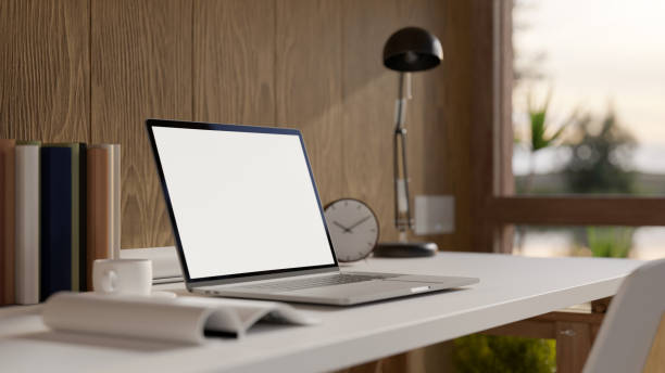 istock Home workspace with laptop mockup and accessories on table over wooden wall 1404586893