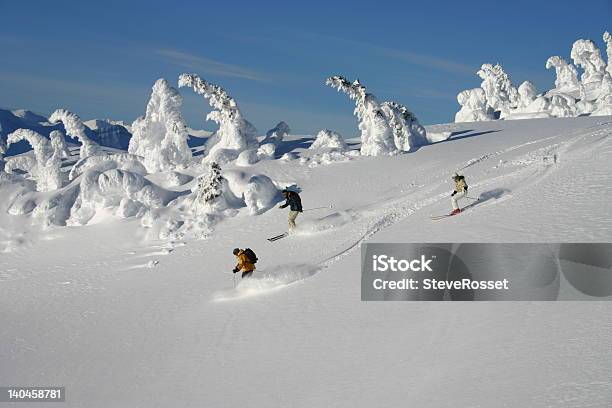 A Group Of People Skiing Down A Slight Slope Stock Photo - Download Image Now - Activity, Adventure, Beauty