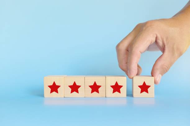 istock Five stars feedback, review and rating concept. Hand putting blocks with five stars shape. 1404588659