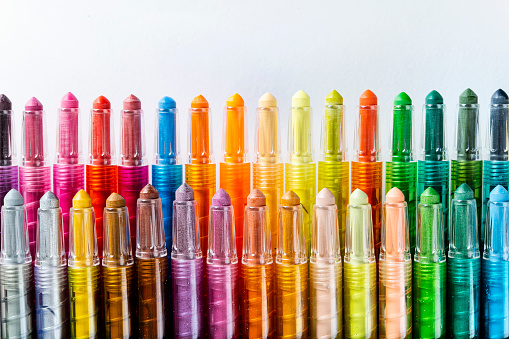 Multicolored colored pencils are lying on the desk