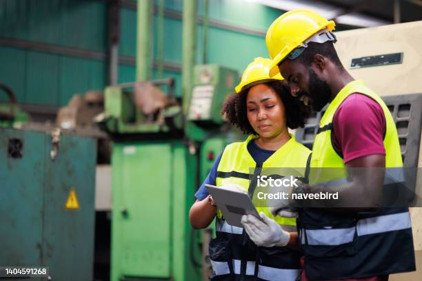 Professional Mechanical Engineer Team Working On Digital Tablet Computer At Industrial Manufacturing Factory Engineer Operating Lathe Machinery Product Quality Inspection Stock Photo - Download Image Now