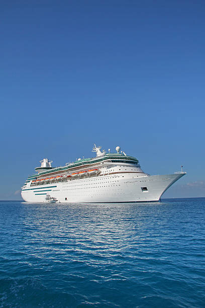 Cruise ship sailing on a clear day Vertical picture of a large modern cruise ship. cruise ship photos stock pictures, royalty-free photos & images