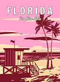 istock Retro Poster Florida Beach. Lifeguard house on the beach, palm, coast, surf, ocean 1404598885