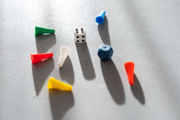 istock Colored game chips and playing cubes laid out on a gray background. entertainment, games at home for the whole family, the concept of board games. Board game. Table games 1404599482