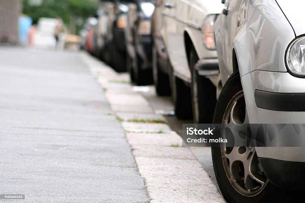 Parking Cars parked by the sideway, focus in front Bumper Stock Photo