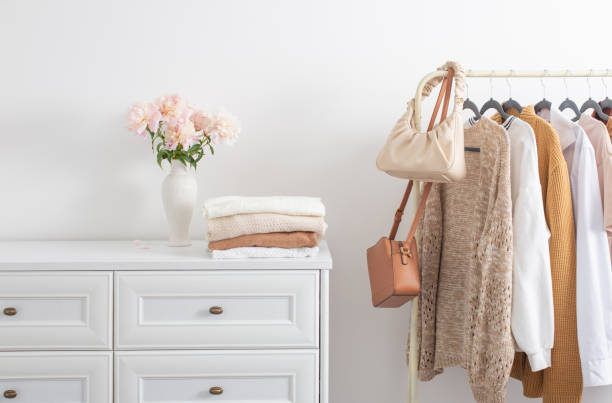 istock female clothes on hangers  in  white room 1404603460