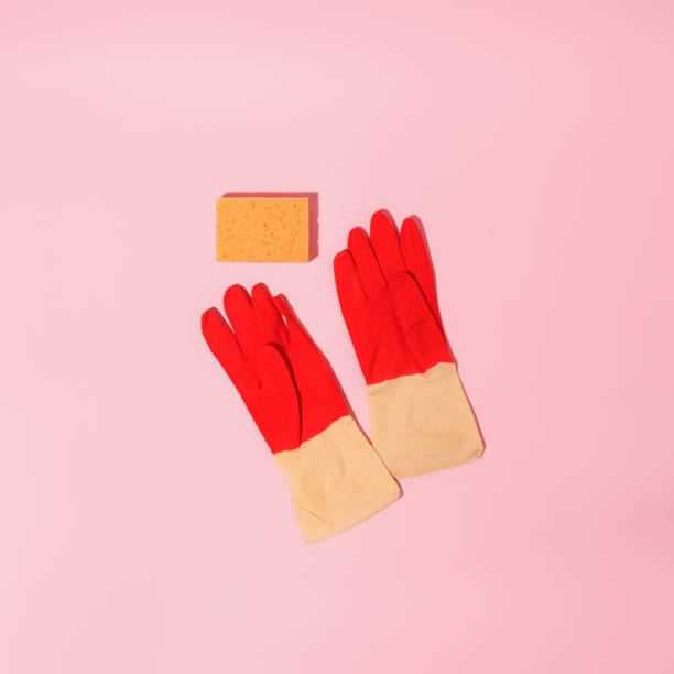 istock Colorful cleaning tool rubber gloves different surfaces in kitchen, bathroom, other rooms. Copy space for text or logo on pink background. Cleaning service concept. Early spring regular clean up, shadow 1404603787