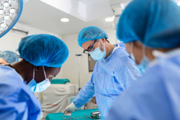 istock Surgeon team in uniform performs an operation on a patient at a cardiac surgery clinic. Modern medicine, a professional team of surgeons, health. 1404605231