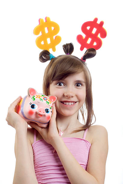 Smiling young business woman thinks of accumulation dollars stock photo