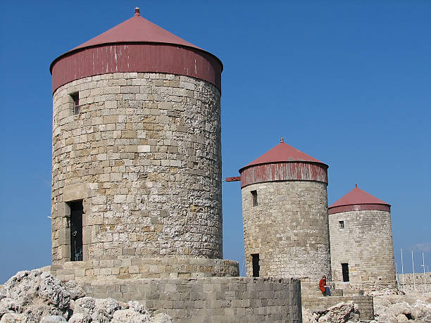 three old windmills and a lady stock photo