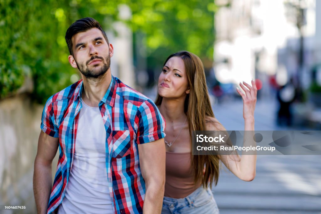 Modern couple with relationship problems in the city.Arguing young couple with problems outdoors in the city Angry man and woman quarreling on street. Distraught Stock Photo