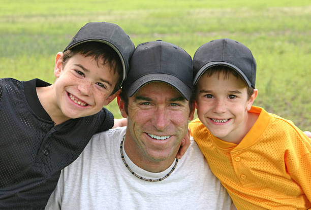 istock Dad and his two boys wearing matching baseball caps 140460941