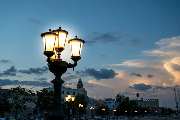 Bari, Puglia, Italy. August 2021. The waterfront is characterized by beautiful street lamps. People gather along this promenade to enjoy the cool of the evening.