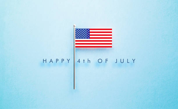 istock Happy 4th Of July Message Next to Tiny American Flag on Blue Background 1404609838