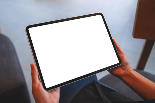 istock Mockup image of a woman holding digital tablet with blank white desktop screen 1404610069