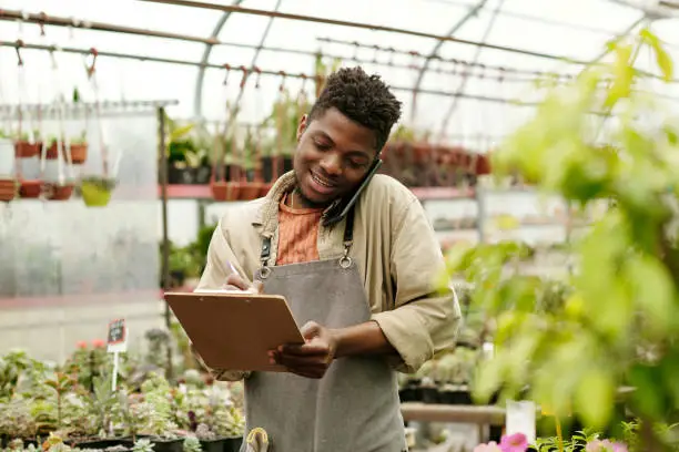 Photo of Flower seller taking an order by mobile phone