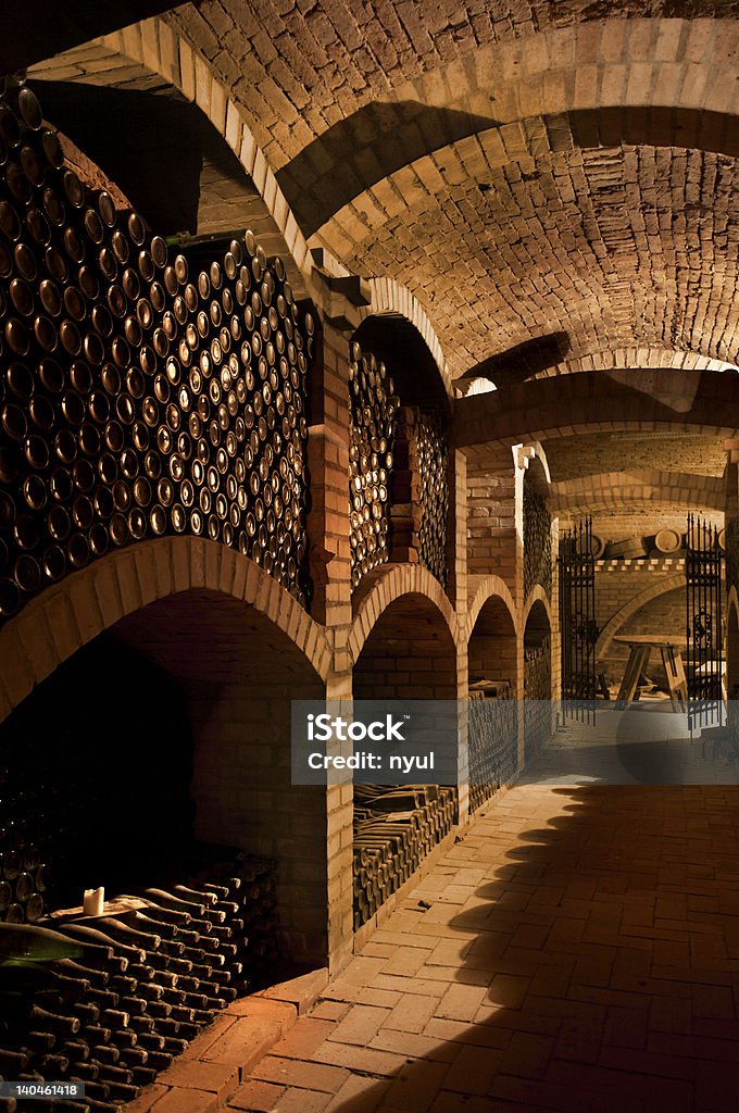 Winecellar Winebottles stacked in the old cellar of the winery. Abundance Stock Photo