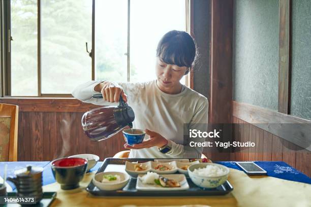Woman Staying At A Mountain Lodge Eats A Japanesestyle Breakfast Before Setting Off To Climb A Mountain Stock Photo - Download Image Now