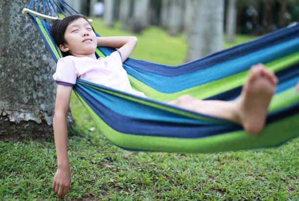 Happy little boy enjoying in hammock during