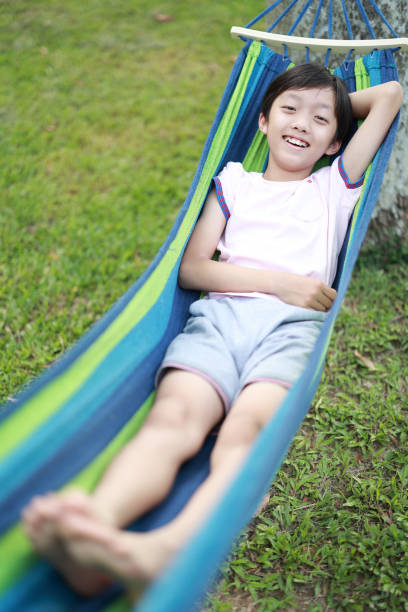 Happy little boy enjoying in hammock during