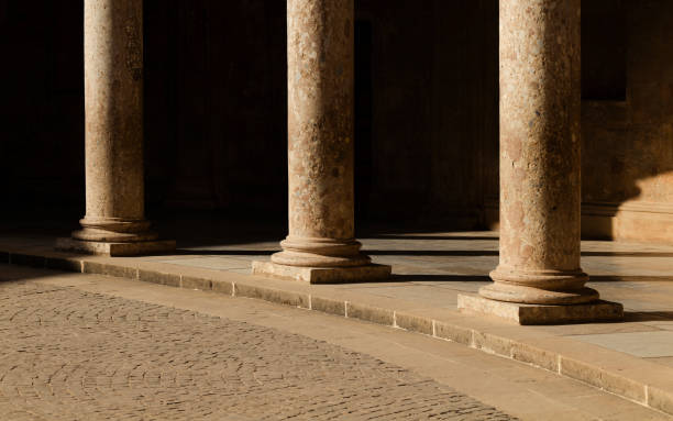 istock Columns of a medieval building with sunlight and shadow. Granada, Spain 1404615325