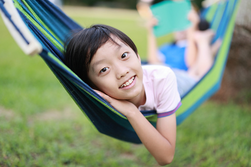 Happy little boy enjoying in hammock during