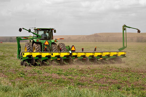 Green tractor working in a field stock photo