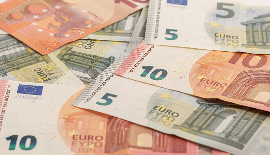 Banknotes of ten and five euros laid out on the table. Money background.