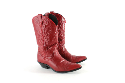 Pair of red leather western boots isolated on a white background