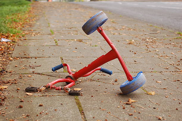 Tricyle Crash A tricycle that was abandoned on the sidewalk for obvious reasons. tricycle stock pictures, royalty-free photos & images