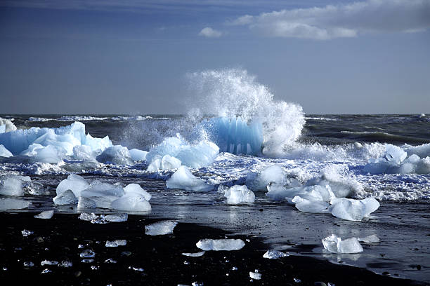 Iceberg being broken by the waves on the black volcanic beach Iceland (350dpi)