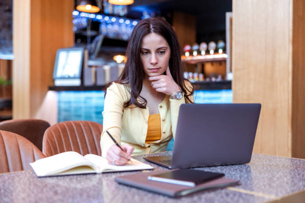 istock Woman using laptop at cafe 1404622457